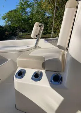 Slide: The Image of 2016 Robalo 206 Cayman boat seating with cup holders, outdoor setting. - 6