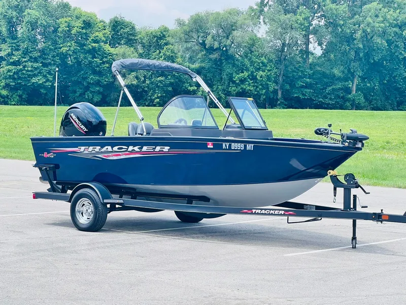 The Image of 2023 Tracker Pro Guide V-175 WT boat on trailer in a parking lot. - 0