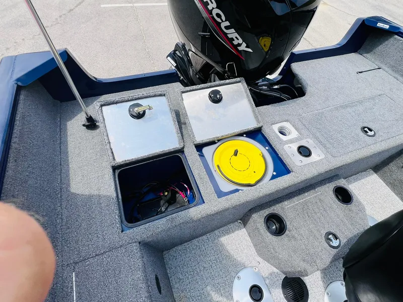 Slide: The Image of 2023 Tracker Pro Guide V-175 WT boat interior with storage compartments and Mercury engine. - 20