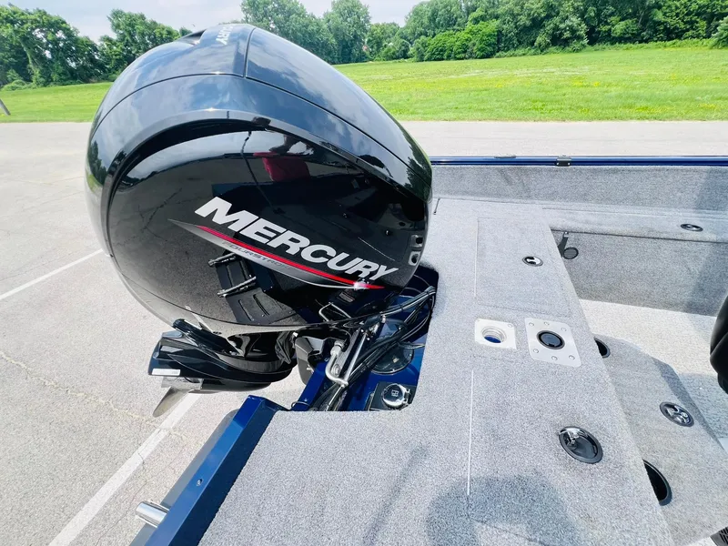 Slide: The Image of 2023 Tracker Pro Guide V-175 WT with Mercury outboard motor, parked on pavement. - 21