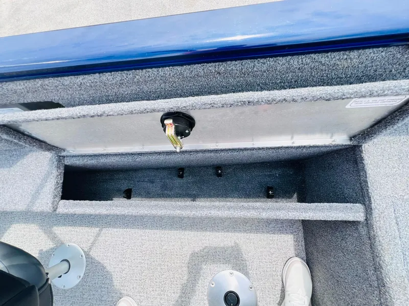 Slide: The Image of 2023 Tracker Pro Guide V-175 WT boat interior storage compartment with gray carpet. - 22