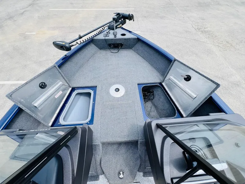 Slide: The Image of 2023 Tracker Pro Guide V-175 WT boat interior with storage compartments and trolling motor. - 27