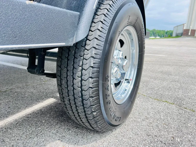 Slide: The Image of Trailer tire of 2023 Tracker Pro Guide V-175 WT on pavement. - 37