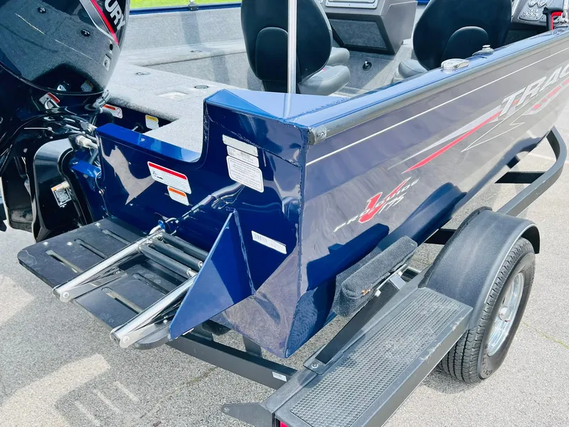 Slide: The Image of 2023 Tracker Pro Guide V-175 WT boat rear view with motor and trailer. - 8