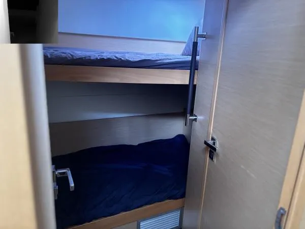 Slide: The Image of Bunk beds inside a 2012 Lagoon 560 yacht cabin. - 11