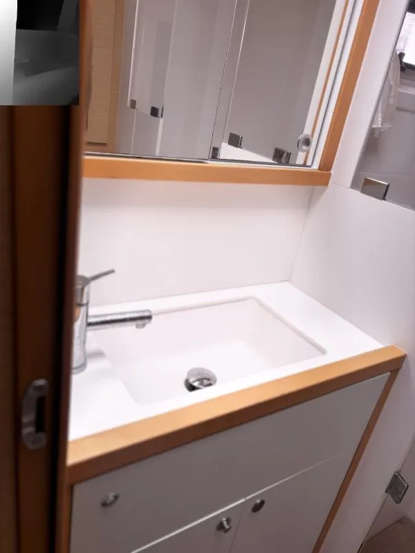 Slide: The Image of Bathroom sink area in a 2012 Lagoon 560 yacht, featuring modern fixtures. - 12