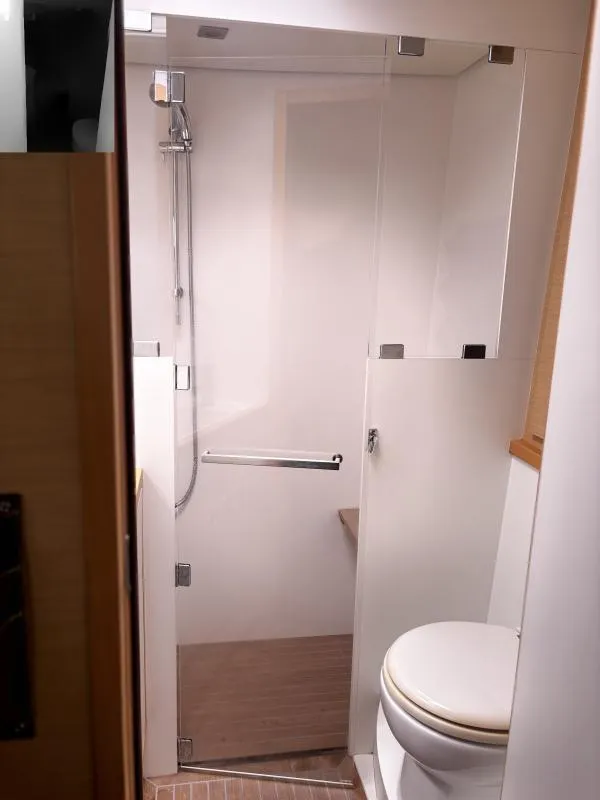 Slide: The Image of Bathroom interior of a 2012 Lagoon 560 yacht, featuring a shower and toilet. - 13