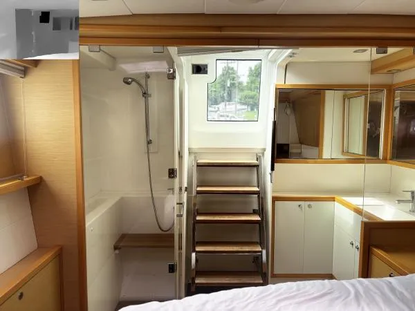Slide: The Image of Luxurious Lagoon 560 yacht interior, featuring a modern bathroom and wooden accents, 2012 model. - 18
