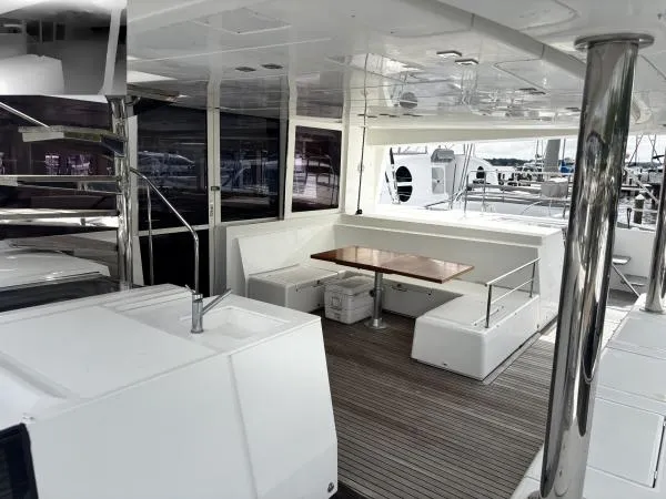 Slide: The Image of Spacious deck of 2012 Lagoon 560 yacht with seating and table. - 19