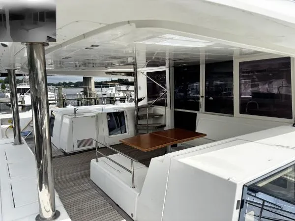 Slide: The Image of Spacious deck of 2012 Lagoon 560 catamaran with seating and table. - 20