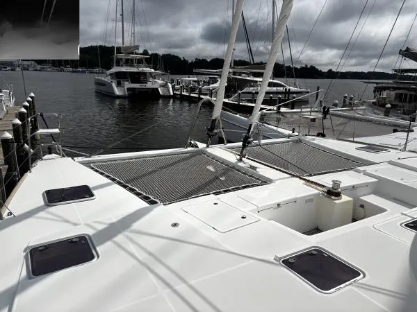 Slide: The Image of Catamaran Lagoon 560, 2012 model, docked at marina with overcast sky. - 21