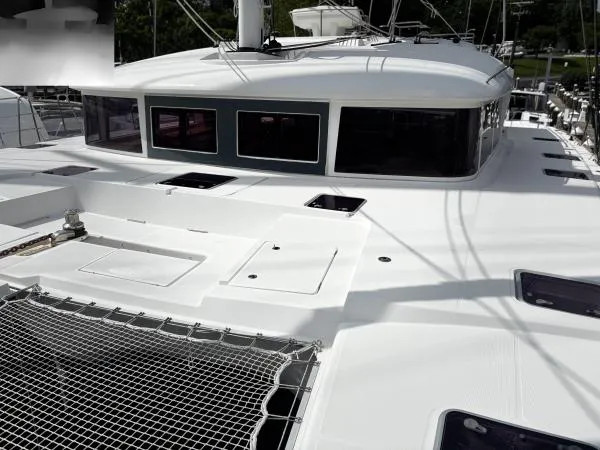 Slide: The Image of 2012 Lagoon 560 catamaran deck with netting and sleek design. - 22