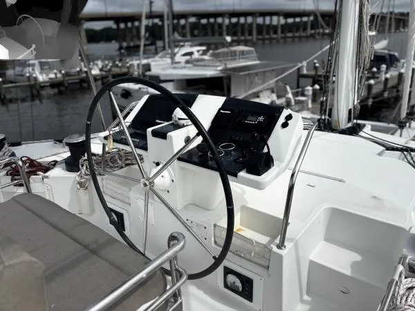 Slide: The Image of Helm of 2012 Lagoon 560 yacht with marina background. - 25