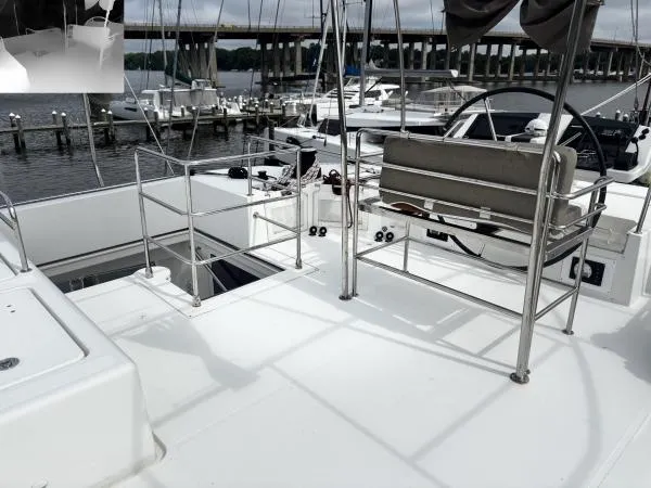 Slide: The Image of Lagoon 560 yacht deck, 2012 model, featuring seating and marina view. - 26