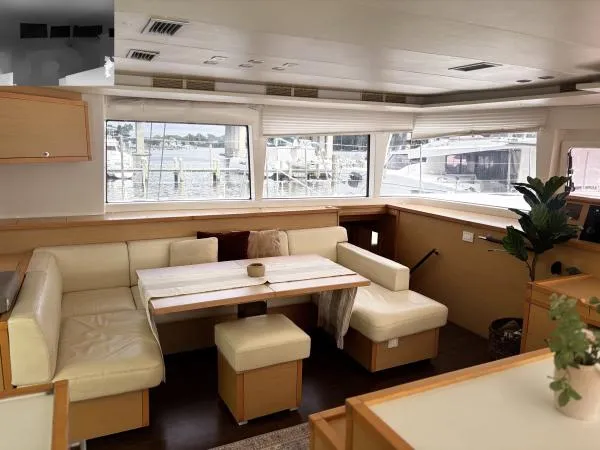 Slide: The Image of Interior of 2012 Lagoon 560 yacht with beige seating and large windows. - 3