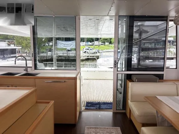 Slide: The Image of Interior view of 2012 Lagoon 560 yacht, featuring modern kitchen and dining area. - 4