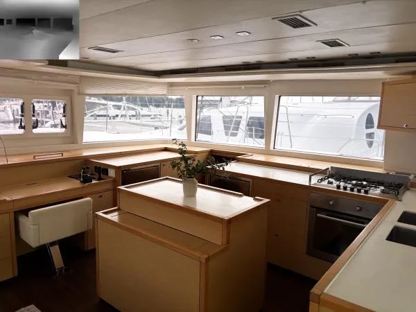 Slide: The Image of Luxurious interior of a 2012 Lagoon 560 yacht with modern kitchen and panoramic windows. - 6