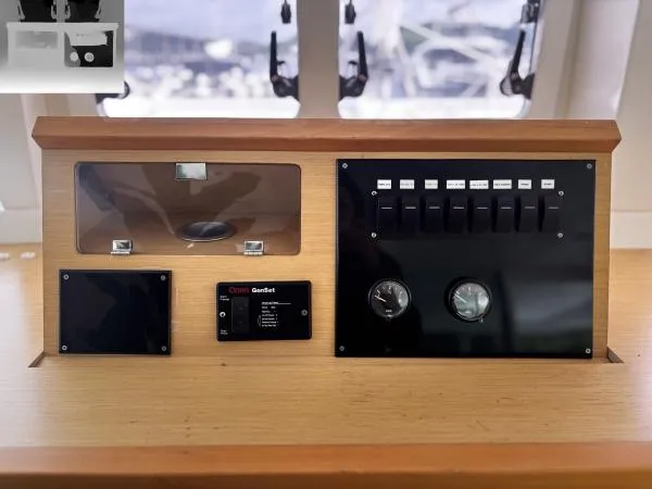 Slide: The Image of Control panel of a 2012 Lagoon 560 yacht with switches and gauges. - 7