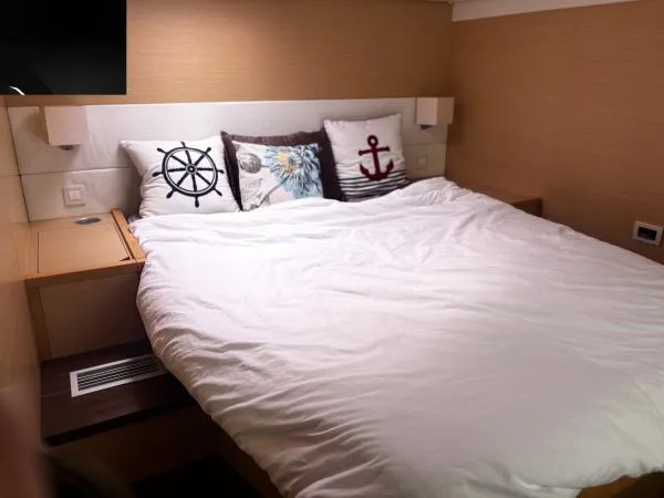 Slide: The Image of Cozy bedroom in 2012 Lagoon 560 yacht with nautical-themed pillows. - 9