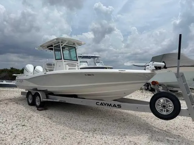 The Image of 2022 Caymas 28 Twin boat on trailer under cloudy sky. - 0