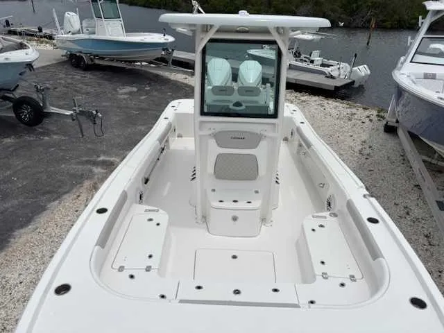 Slide: The Image of 2022 Caymas 28 Twin boat with spacious deck and dual engines, docked near water. - 11