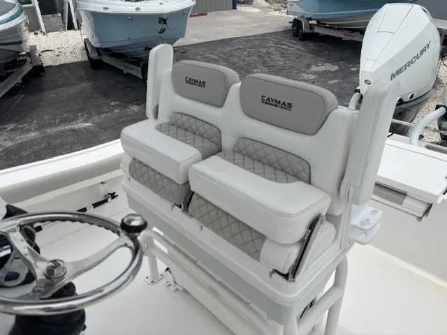 Slide: The Image of 2022 Caymas 28 Twin boat interior with dual cushioned seats and steering wheel. - 6