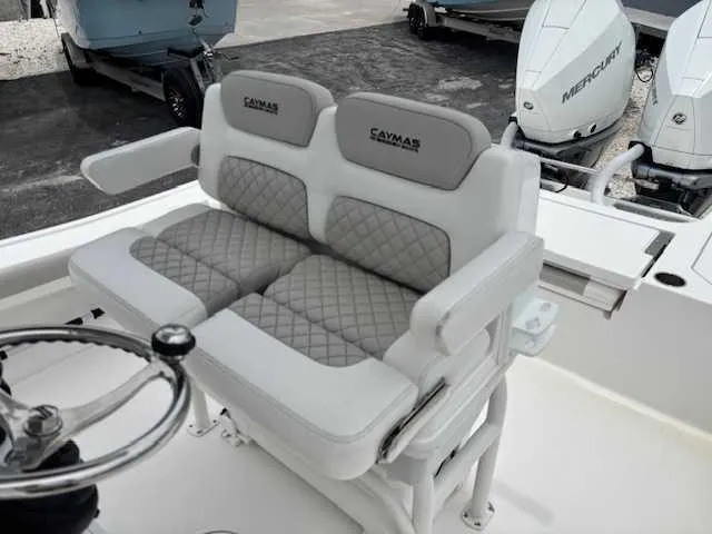 Slide: The Image of 2022 Caymas 28 Twin boat seating with dual Mercury engines in the background. - 7