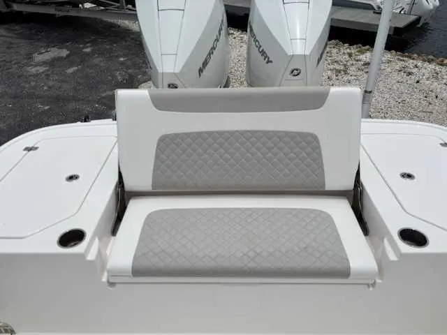 Slide: The Image of 2022 Caymas 28 Twin boat seat with quilted design and Mercury engines in background. - 9