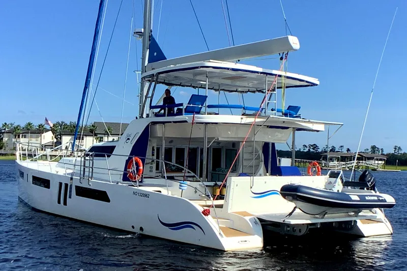 Slide: The Image of 2021 Royal Cape Catamarans Majestic 570 Flybridge on water, featuring spacious deck and flybridge. - 0