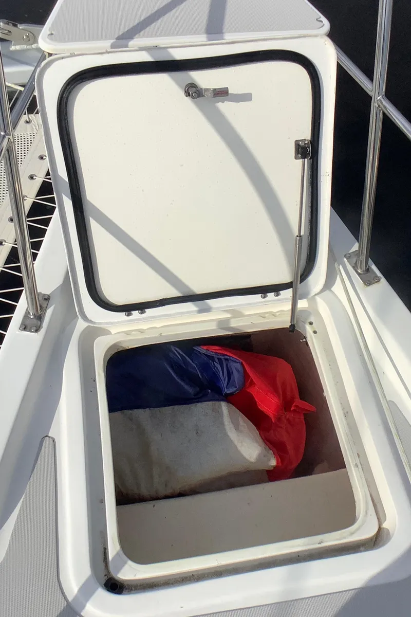 Slide: The Image of Open storage compartment on 2021 Royal Cape Catamarans Majestic 570 Flybridge. - 15