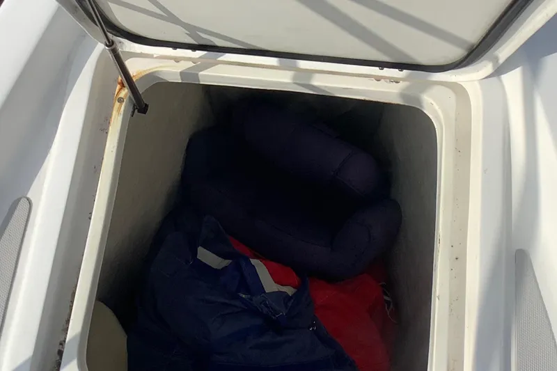 Slide: The Image of Storage compartment on 2021 Royal Cape Catamarans Majestic 570 Flybridge, containing cushions and fabric. - 16