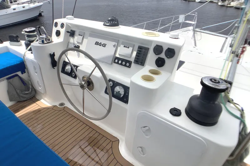 Slide: The Image of Flybridge helm of 2021 Royal Cape Catamarans Majestic 570, featuring modern navigation equipment. - 20