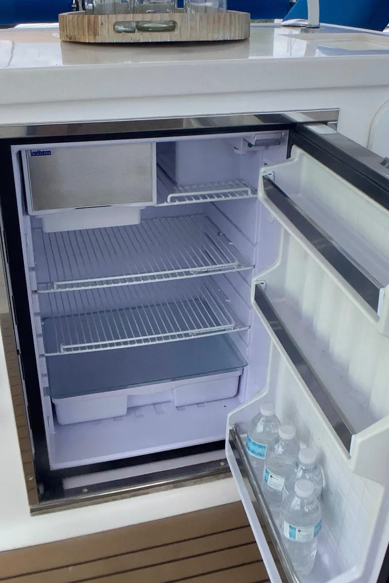 Slide: The Image of Open fridge on Royal Cape Catamarans Majestic 570 Flybridge, stocked with water bottles. - 30