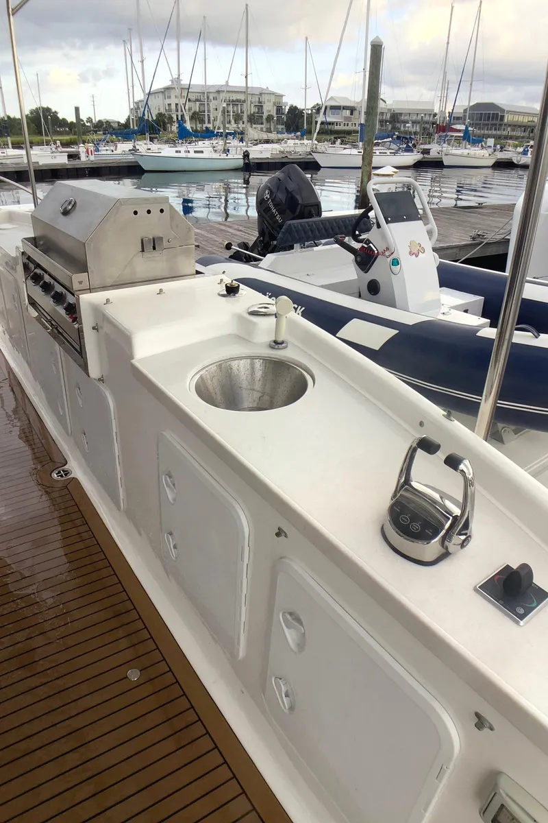Slide: The Image of Flybridge of 2021 Royal Cape Catamarans Majestic 570, featuring a sink and control panel. - 35