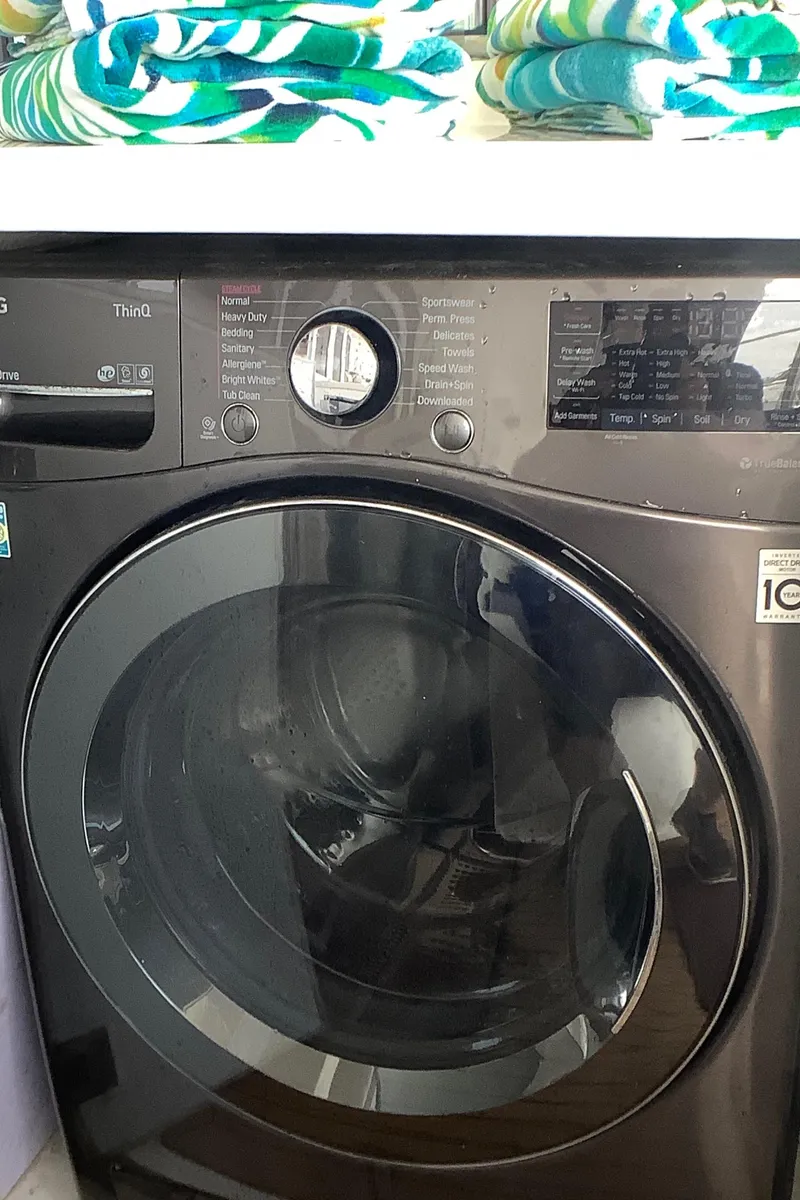Slide: The Image of Front-loading washing machine with digital controls and colorful towels on top. - 48