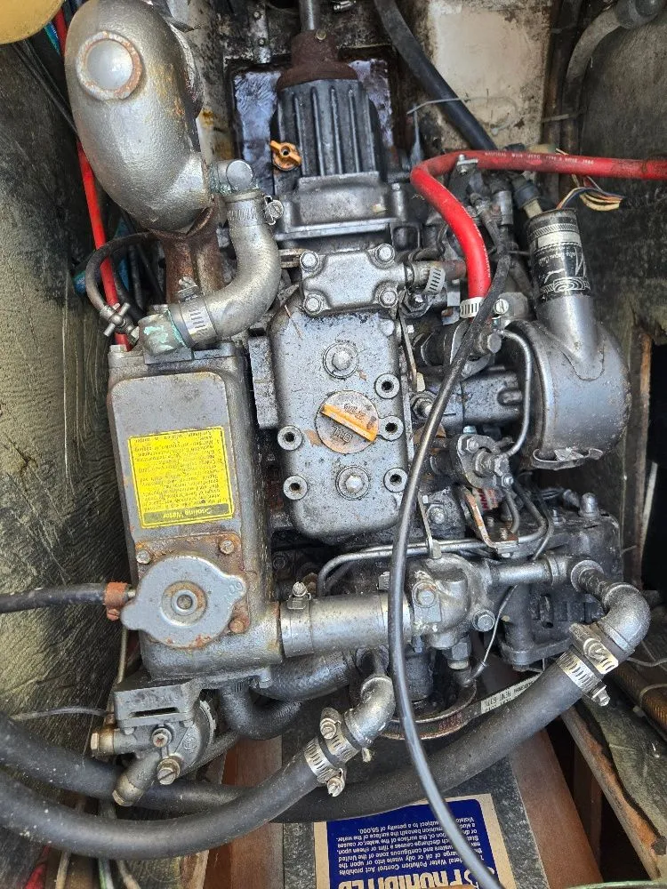 Slide: The Image of Engine of a 1986 Island Packet IP27 sailboat, showing detailed mechanical components. - 13