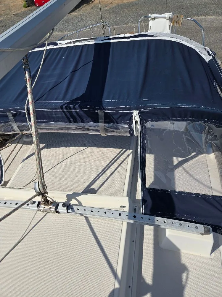 Slide: The Image of 1986 Island Packet IP27 sailboat deck with blue canvas cover and rigging. - 17