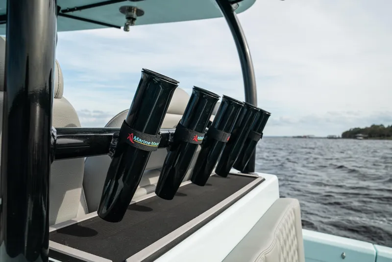 Slide: The Image of 2026 Front Runner 39 CC boat with rod holders on a calm water backdrop. - 18