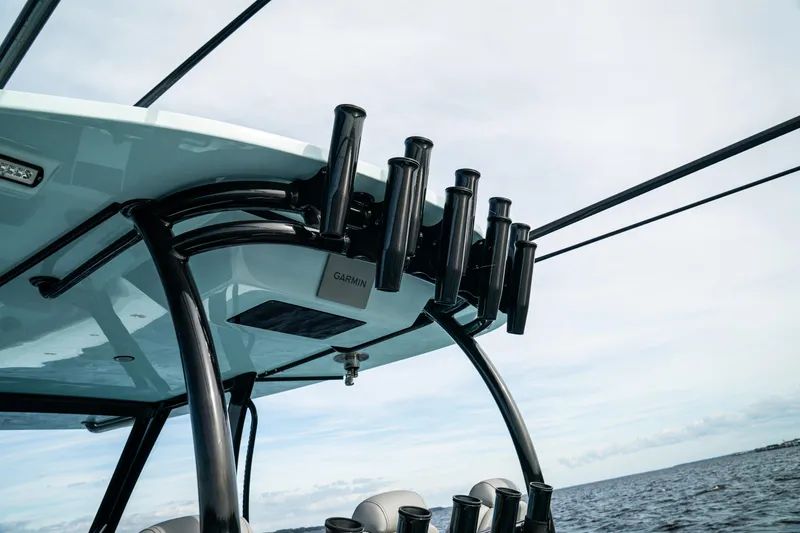 Slide: The Image of 2026 Front Runner 39 CC boat with rod holders and ocean backdrop. - 19