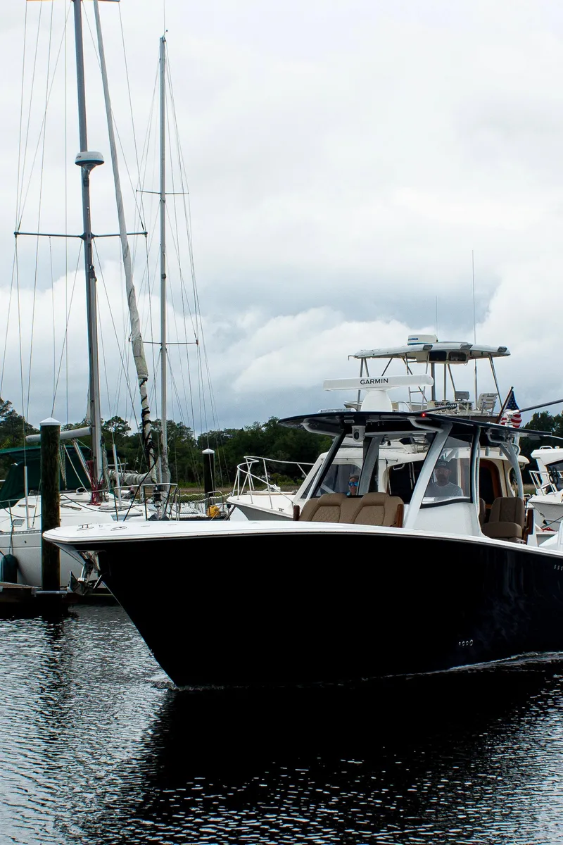 Slide: The Image of 2026 Front Runner 39 CC boat docked in a marina with cloudy skies. - 26