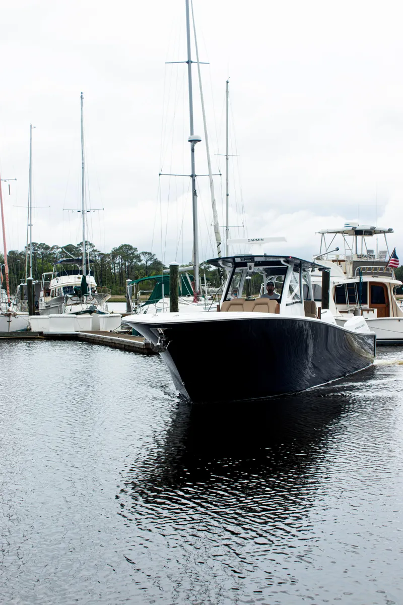 Slide: The Image of 2026 Front Runner 39 CC boat docked in a marina, surrounded by sailboats. - 27