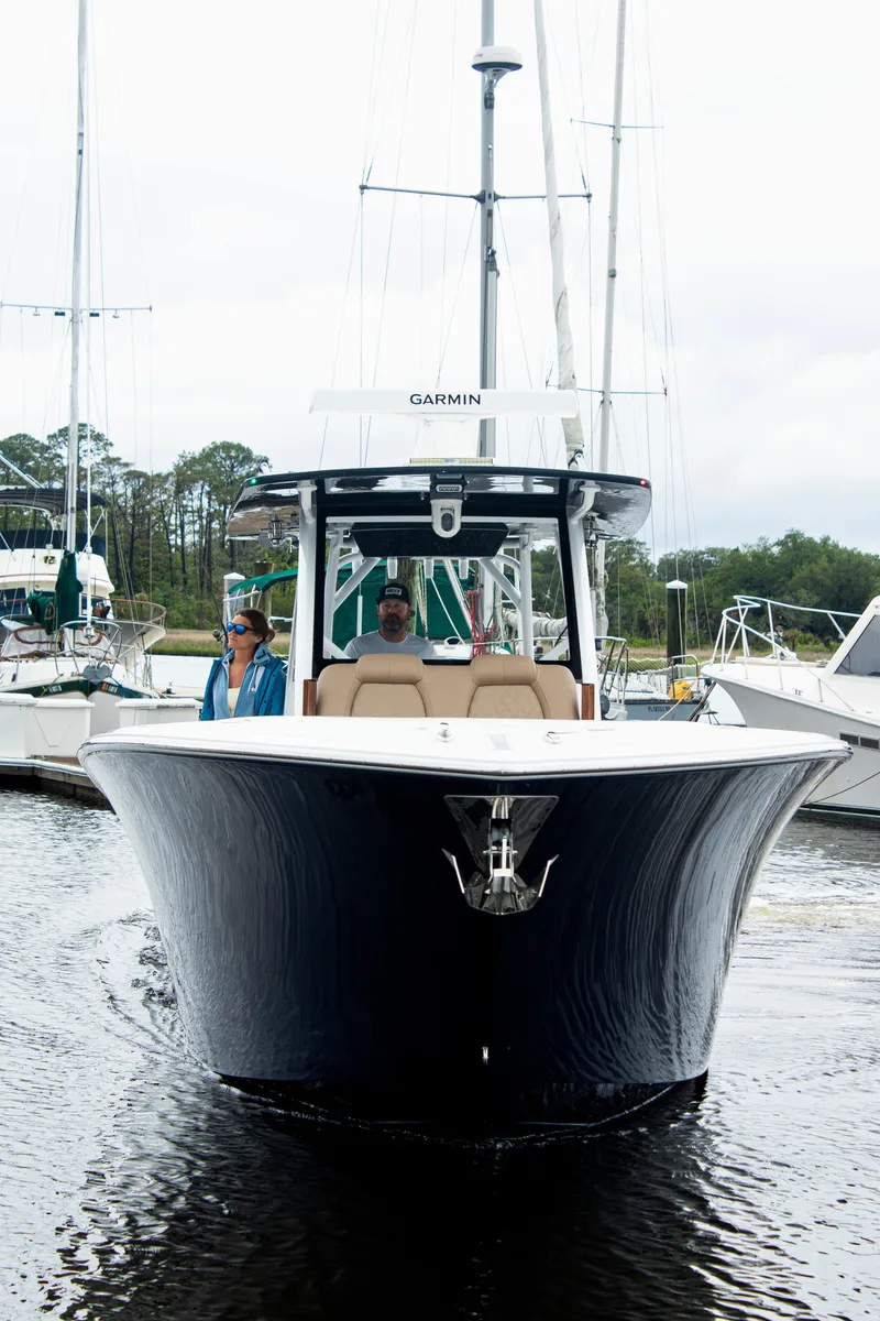 Slide: The Image of 2026 Front Runner 39 CC boat navigating in a marina, featuring sleek design and modern technology. - 28