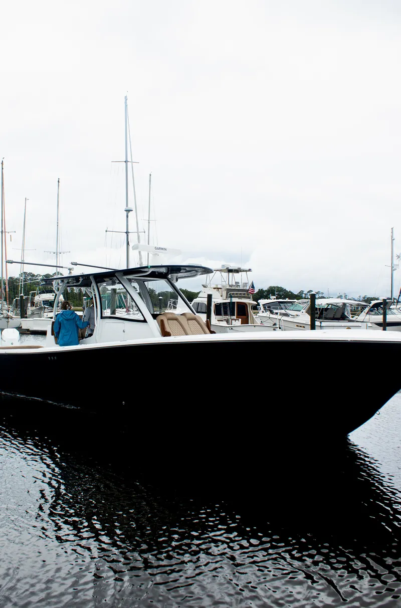 Slide: The Image of 2026 Front Runner 39 CC boat docked in a marina, overcast sky. - 29