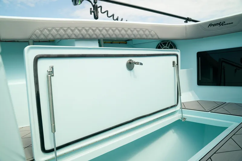 Slide: The Image of 2026 Front Runner 39 CC boat interior with storage compartment and cushioned seating. - 5