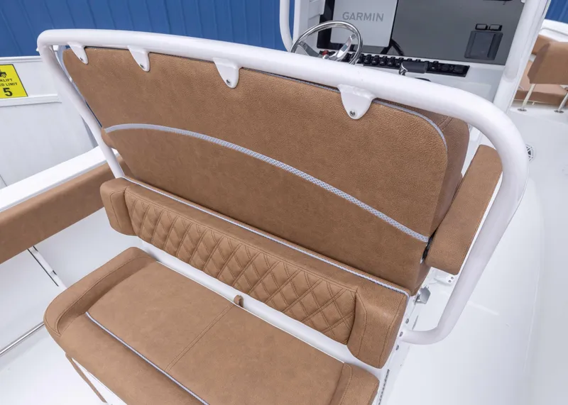 Slide: The Image of 2026 Sea Hunt Ultra 245 SE boat seating with tan upholstery and white accents. - 10