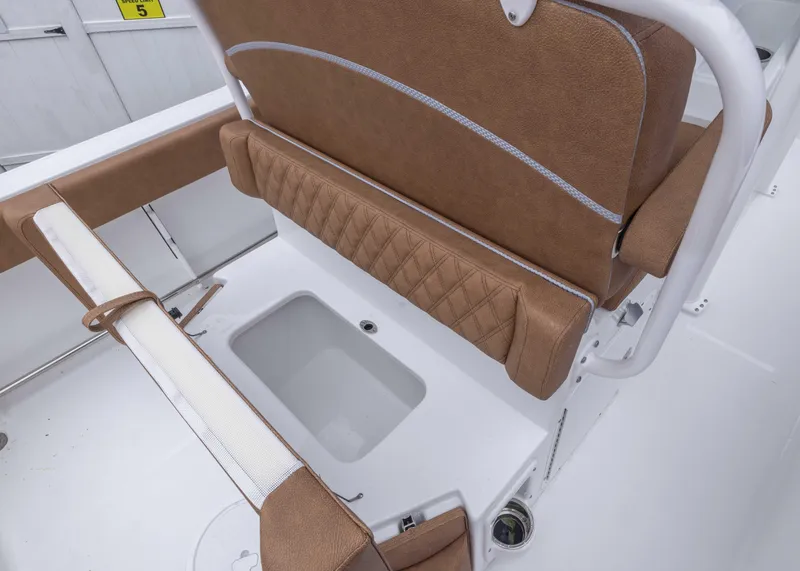Slide: The Image of 2026 Sea Hunt Ultra 245 SE boat seating with storage compartment. - 11
