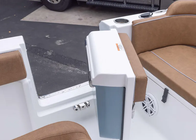 Slide: The Image of 2026 Sea Hunt Ultra 245 SE boat interior with tan seating and cup holders. - 13