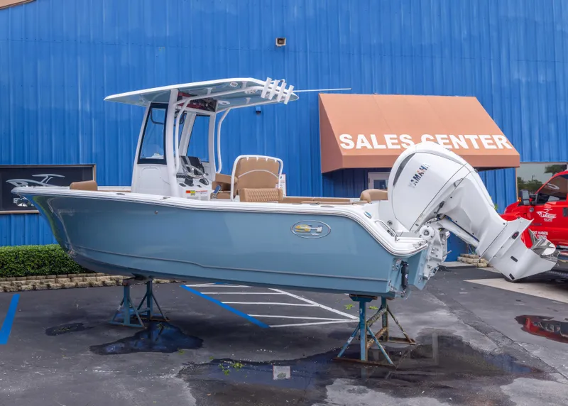 Slide: The Image of 2026 Sea Hunt Ultra 245 SE boat displayed at sales center. - 2