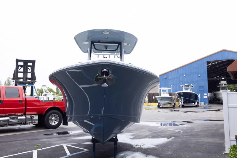 Slide: The Image of 2026 Sea Hunt Ultra 245 SE boat in a marina, front view. - 3