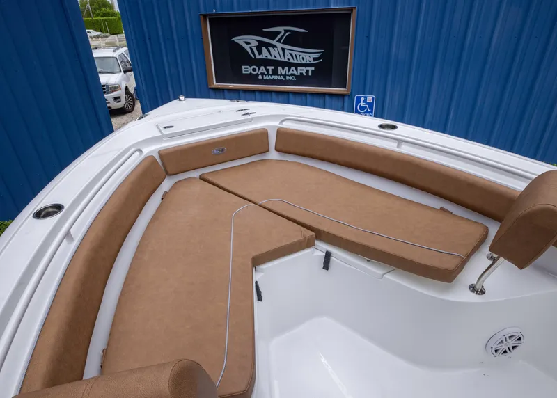 Slide: The Image of 2026 Sea Hunt Ultra 245 SE boat with cushioned seating at Plantation Boat Mart. - 4